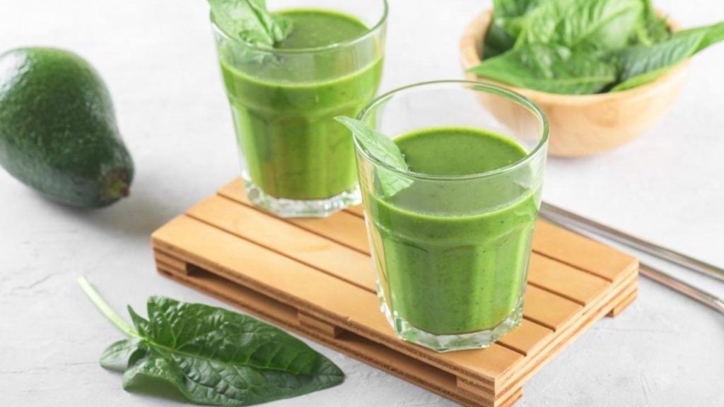 Zelené smoothie v sklenených pohároch pripravené zo špenátu, kelu a avokáda