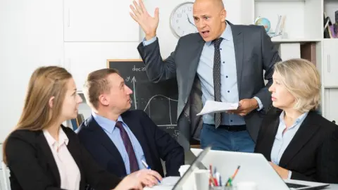 Irritated,Boss,Scolding,Group,Of,Stressed,Managers,For,Incompetence,At