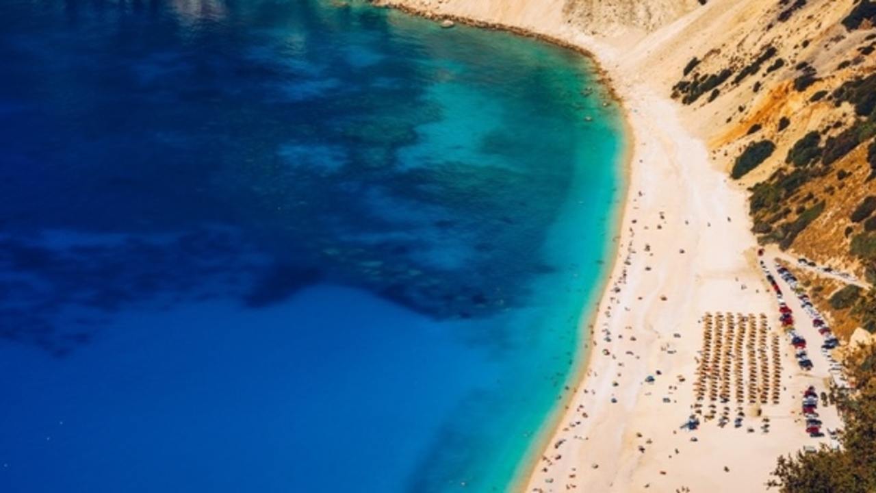 Aerial drone view of iconic turquoise and sapphire bay and beach of Myrtos, Kefalonia (Cephalonia) island, Ionian, Greece. Myrtos beach, Kefalonia island, Greece. Beautiful view of Myrtos beach.