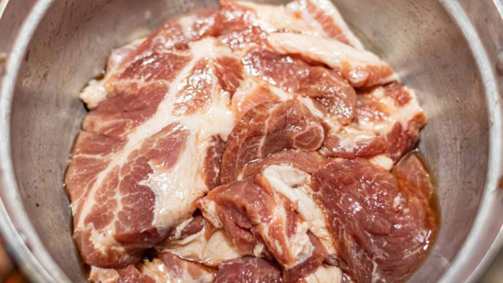 Marinovanie bravčovej krkovičky v pomarančovej šťave s cesnakom a koreninami.